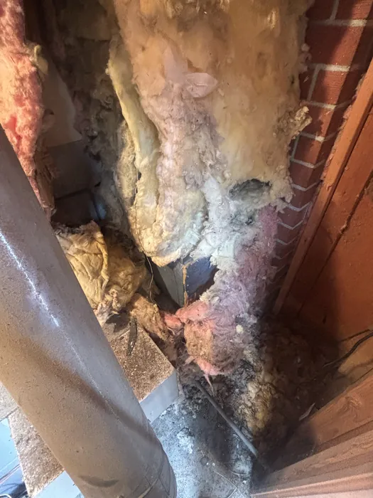 Aging fiberglass batt and round duct run inside a residential attic during a High Desert HVAC inspection.