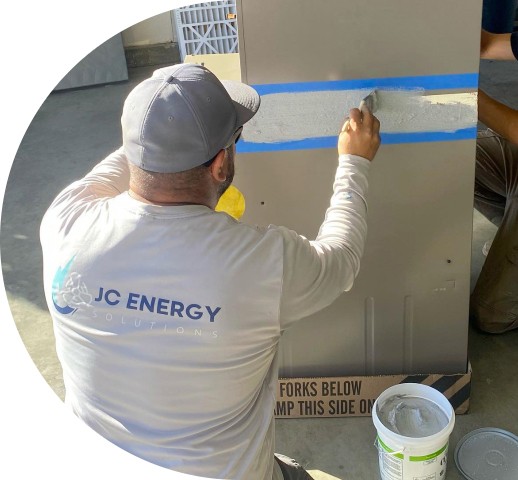 JC Energy Employee Painting HVAC System